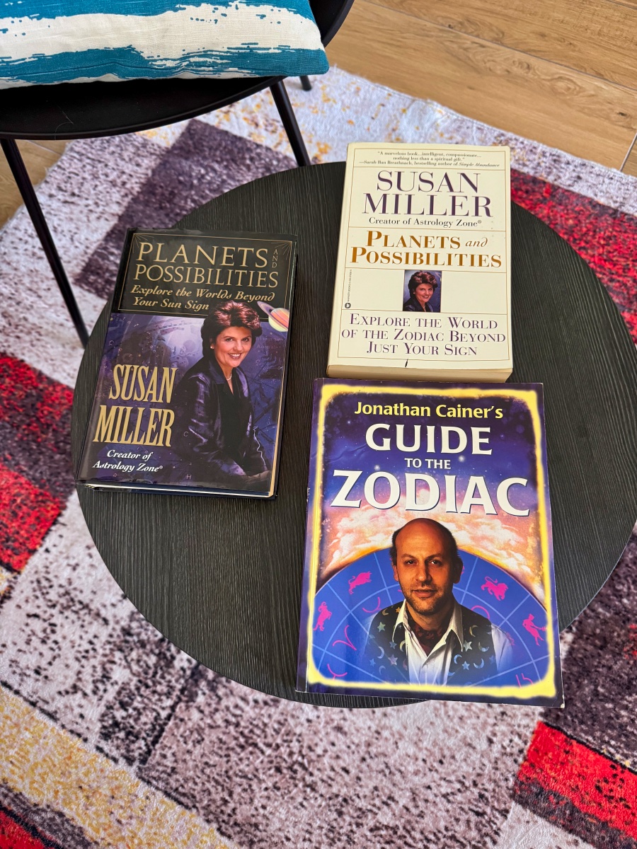 A stack of astrology reference books Claudine reads from